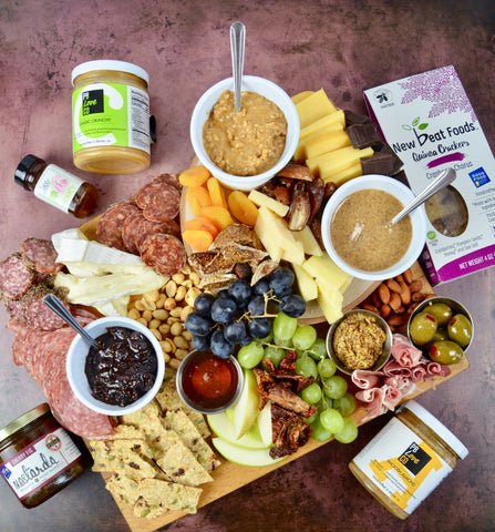 All-natural peanut butter and almond butter. Charcuterie board for mother's day. Party favorites for Mother's Day 2022. Cured meats, cheeses, dried fruit, fresh fruit.