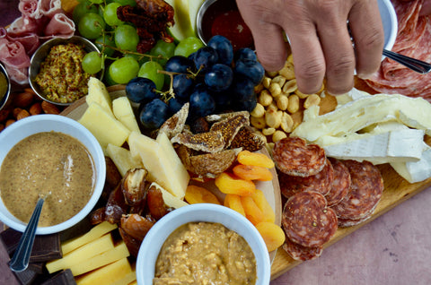 All-natural peanut butter and almond butter. Charcuterie board for mother's day. Party favorites for Mother's Day 2022. Cured meats, cheeses, dried fruit, fresh fruit.