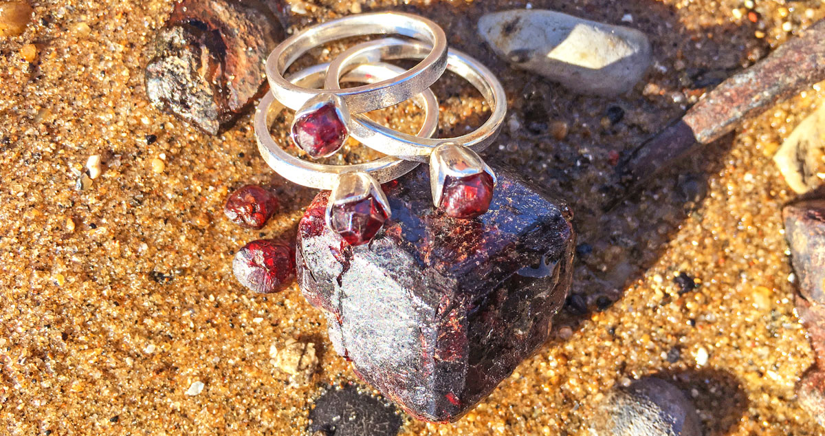 Silver garnet-set rings set on top of the large garnet 