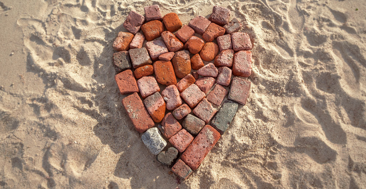 heart on the beach made of bricks