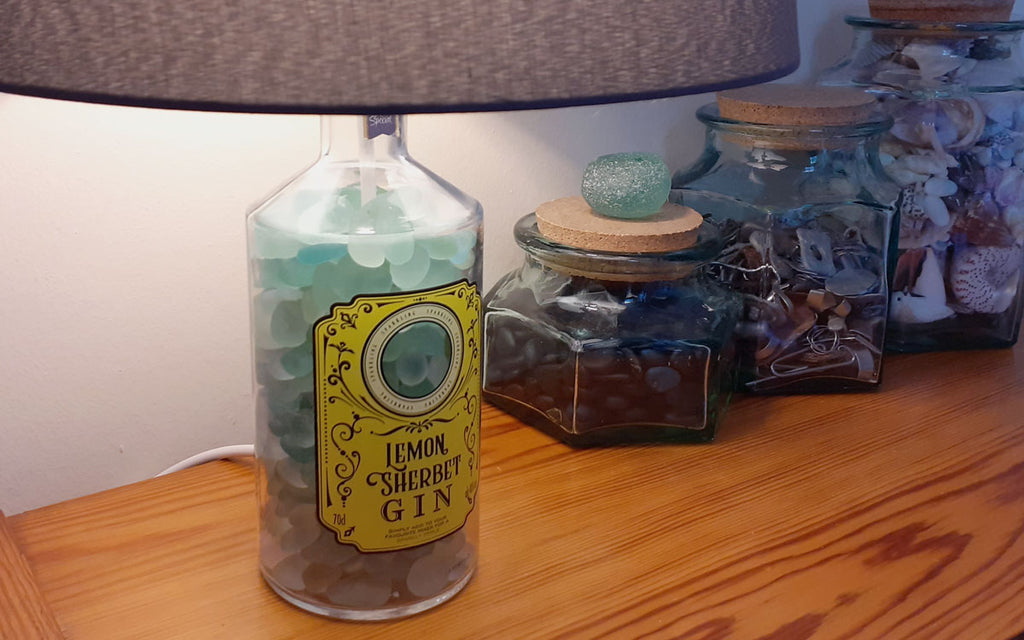bottle lamp with sea glass or shells