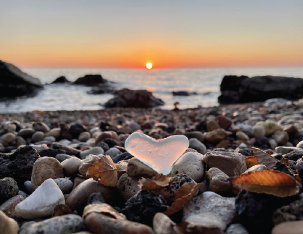 sunset through sea glass heart lake michigan