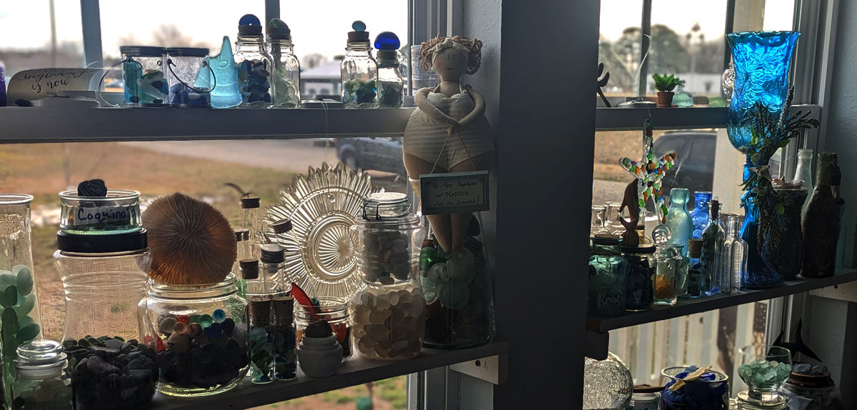 beautiful beach glass collection in window in OBX