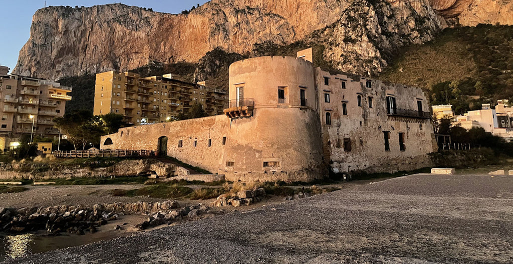 castle overlooking the harbor beach in sicily