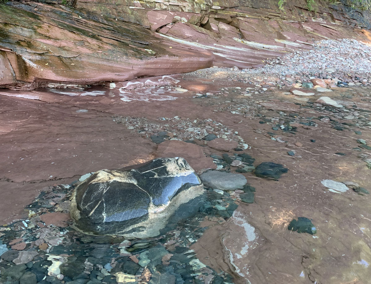 red sandstone rock cobbles and pebbles with smooth eroded edges