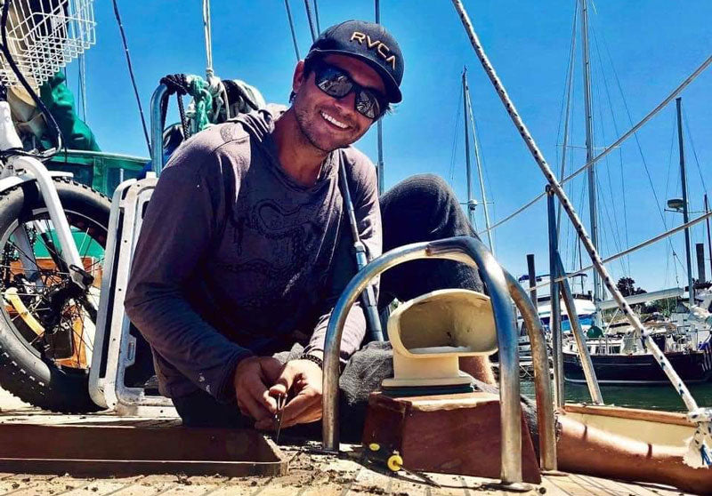 kyle davis on his sailboat searching for beach glass