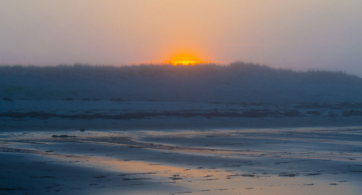 sunrise on new england winter beach