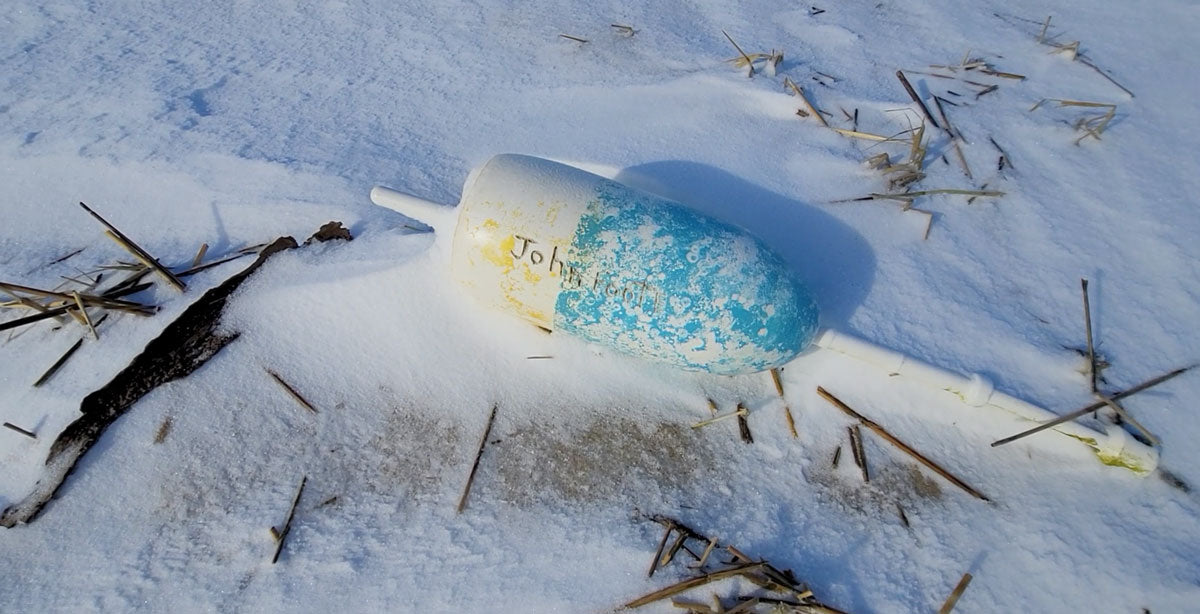 lobster buoy on snowy beach in Massachusetts