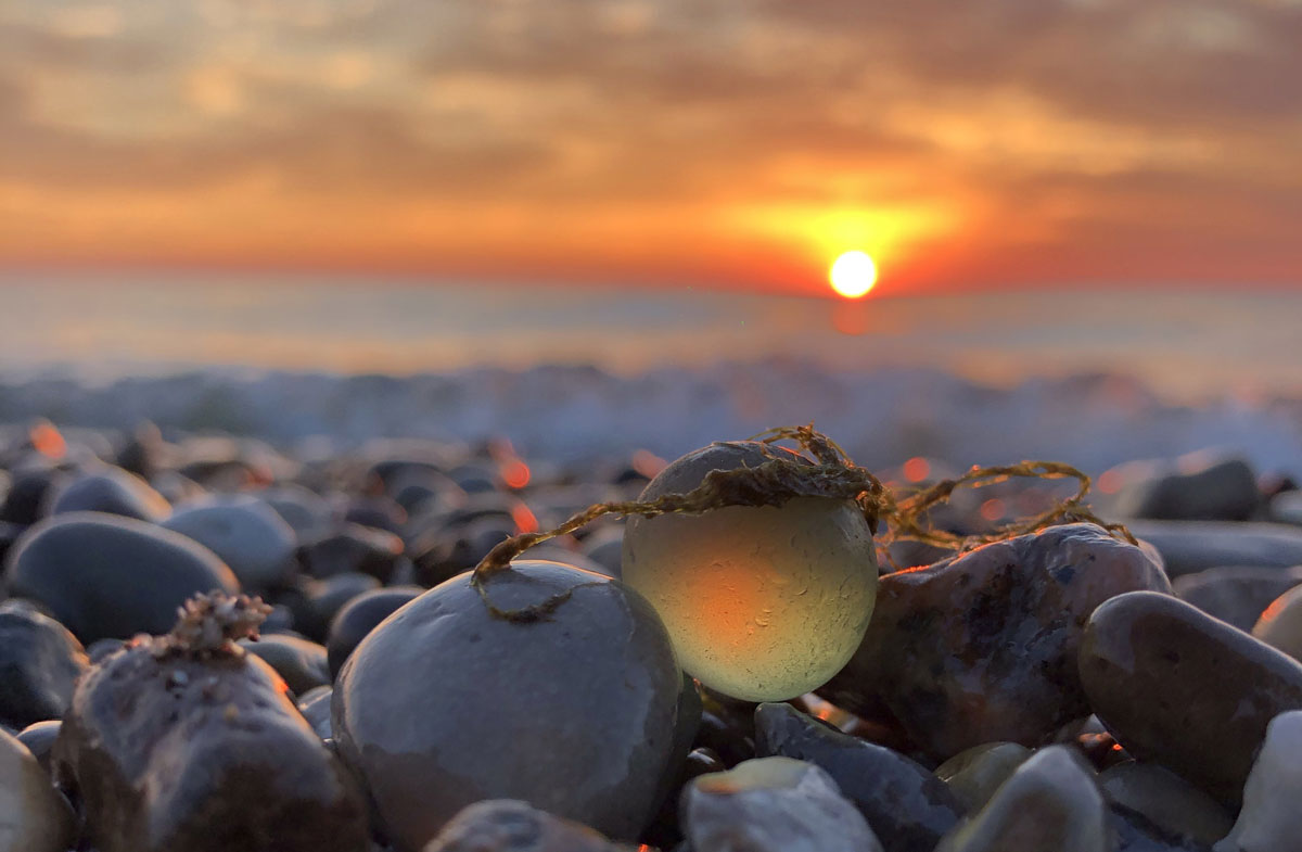 beautiful photo of sea glass marble and sunset