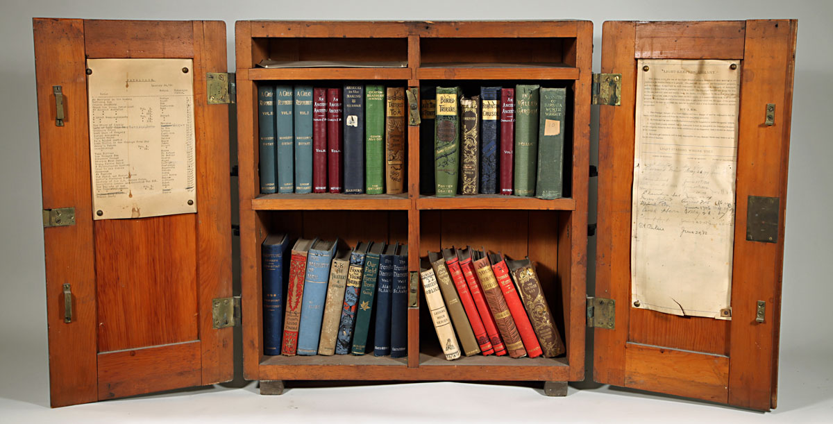 wooden lighthouse library book case with books inside