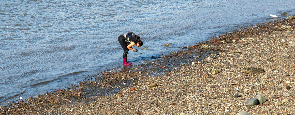 woman mudlarking in london