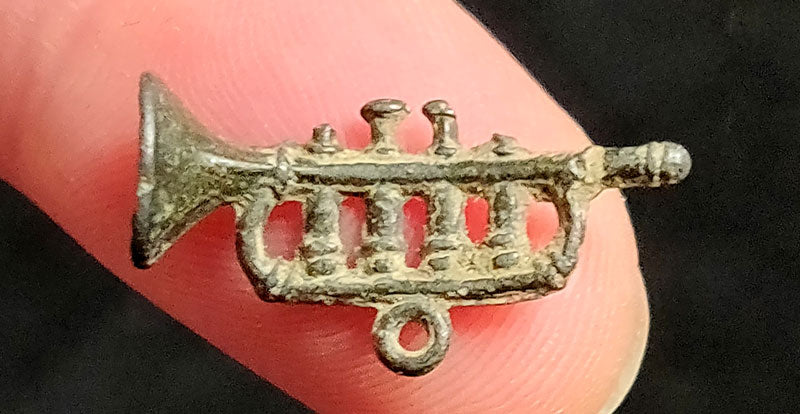 mini trumpet charm found in thames river