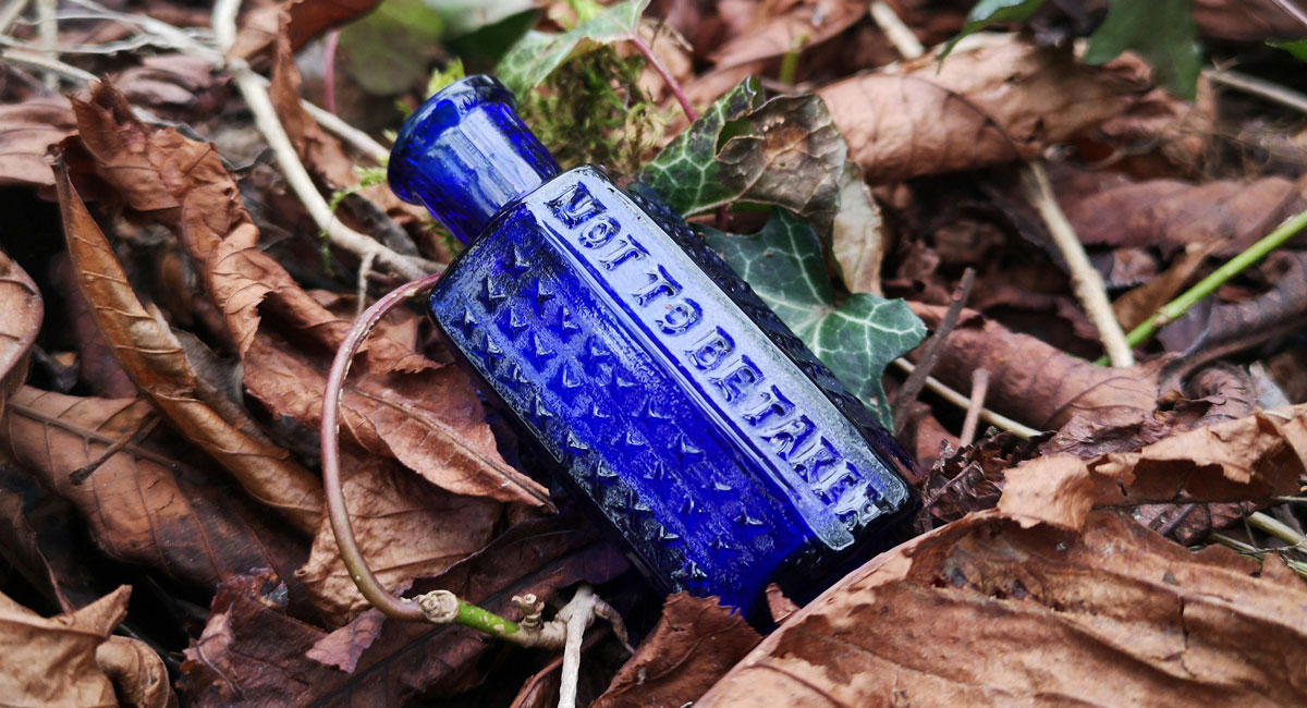 blue retro poison bottle found in english streambed