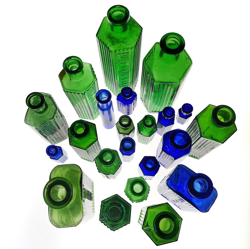 blue and green glass poison bottles from the top