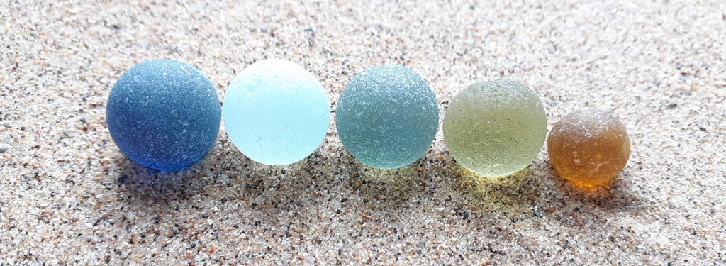 beach marbles on sand