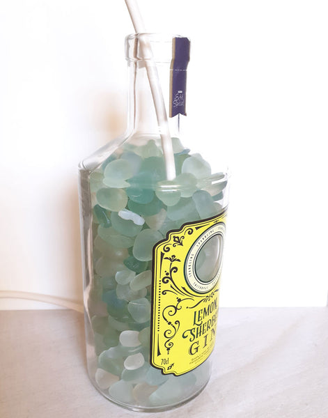 fill bottle with sea glass or shells