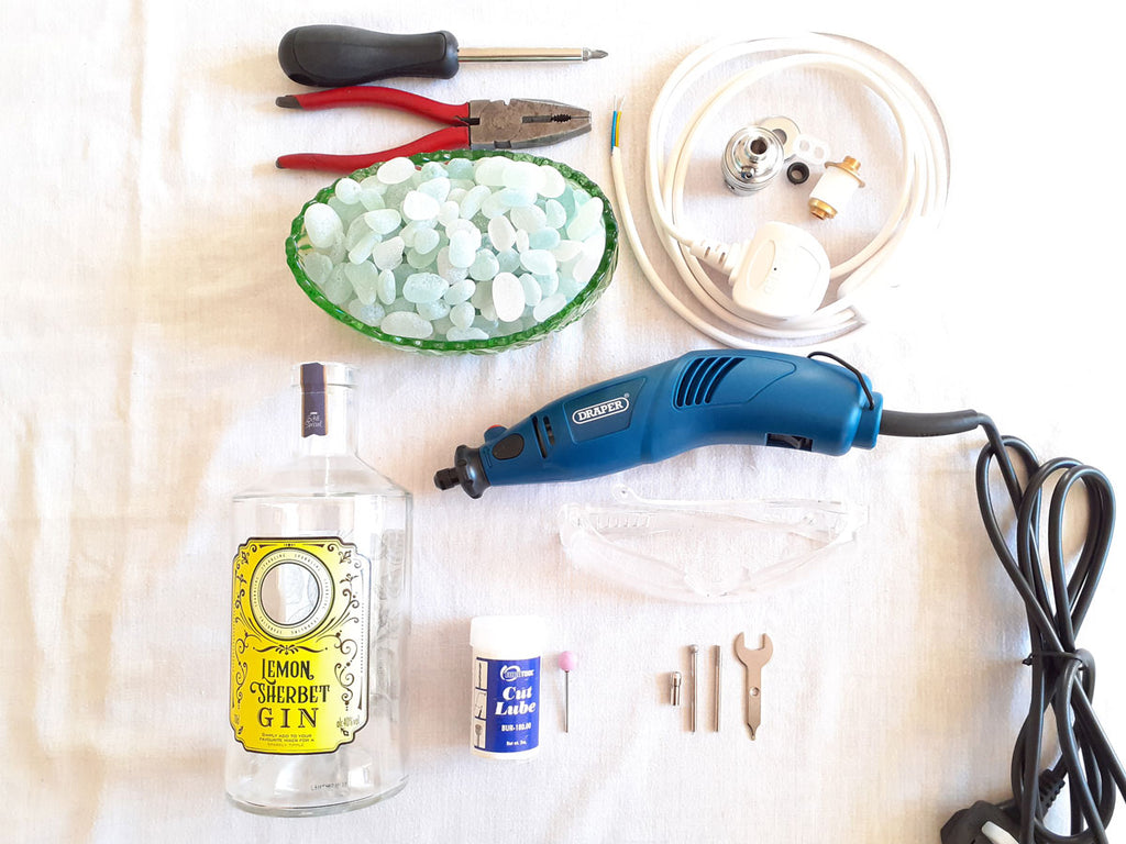 supplies to make a lamp with a bottle and beach finds