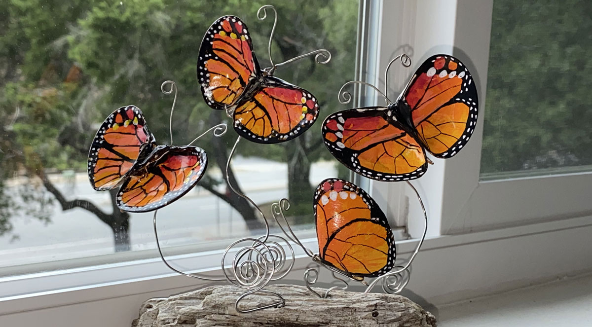 painted seashell butterflies on driftwood stand