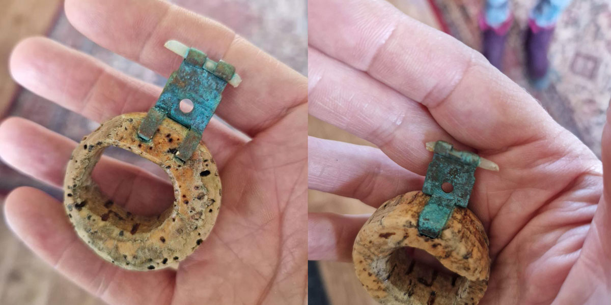 cork circle with metal hinge found on beach
