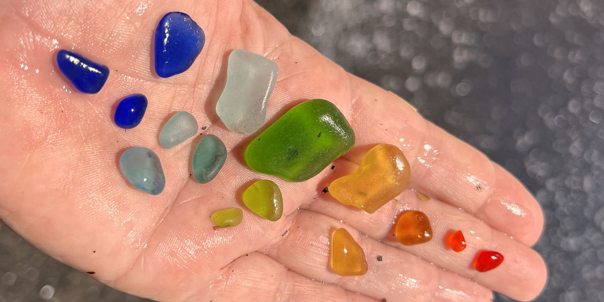 rainbow of sea glass in hand