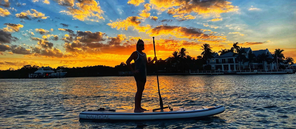 searching for seashells in florida on a SUP