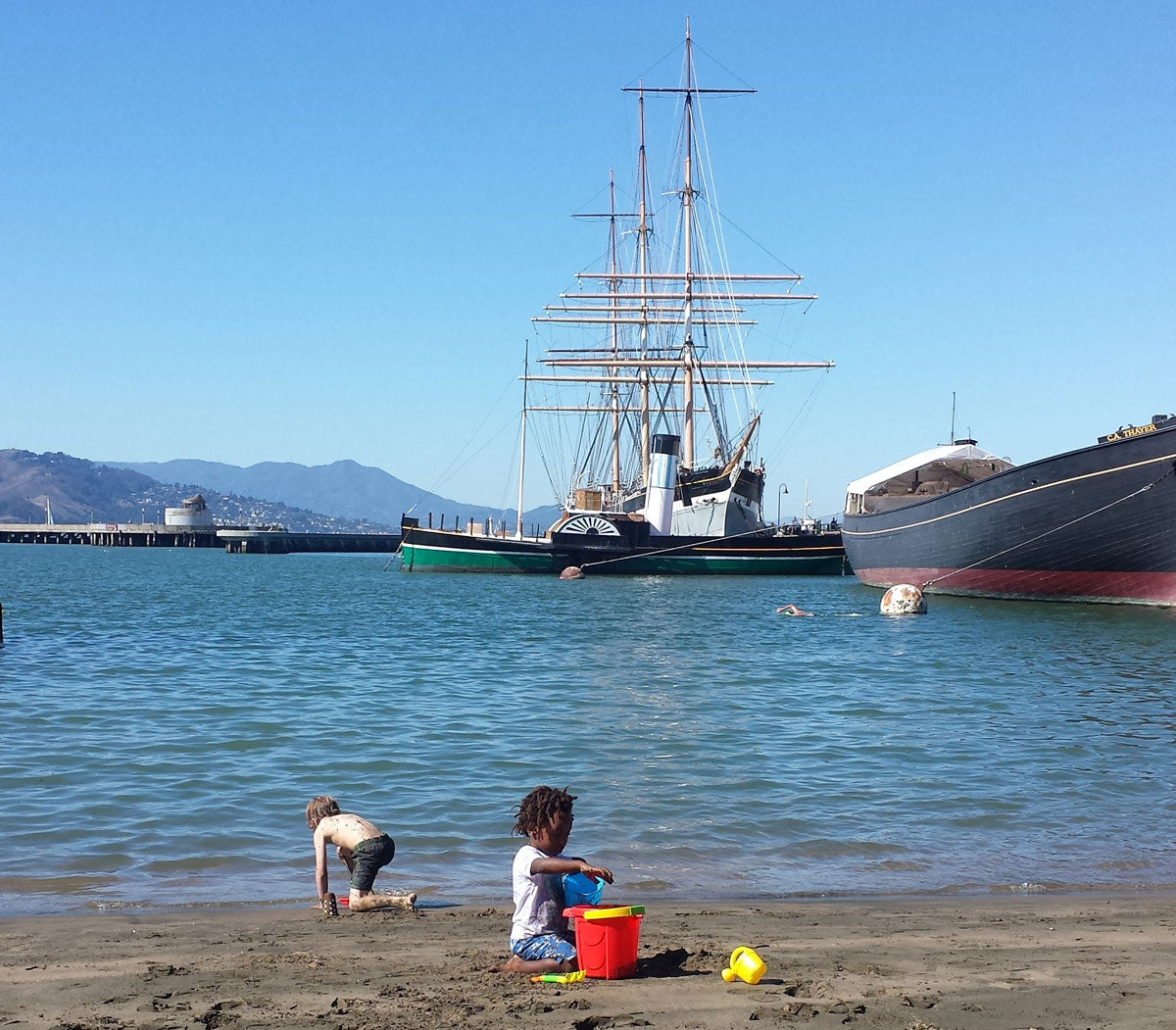 children playing next to haunted ship in san francisco