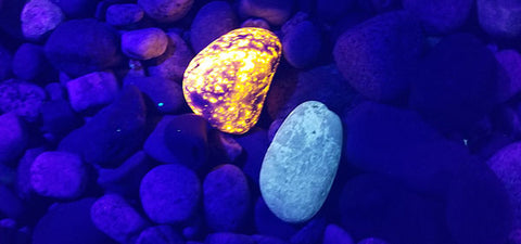 yooperlite glowing on the beach