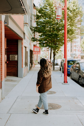 girl with bronde hair color walking down the street of Vancouver's Chinatown