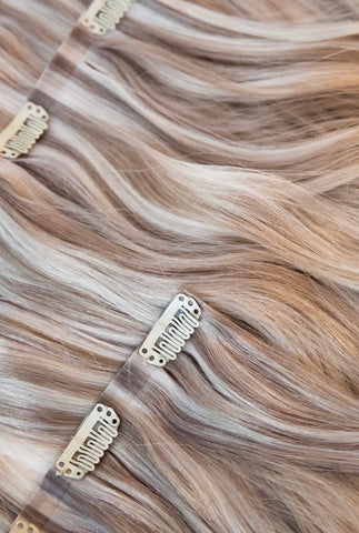 Blonde QALI clip-ins laid out with clips showing to show attachment type