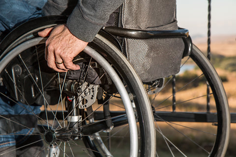 A closeup of an elderly man in a wheelchair