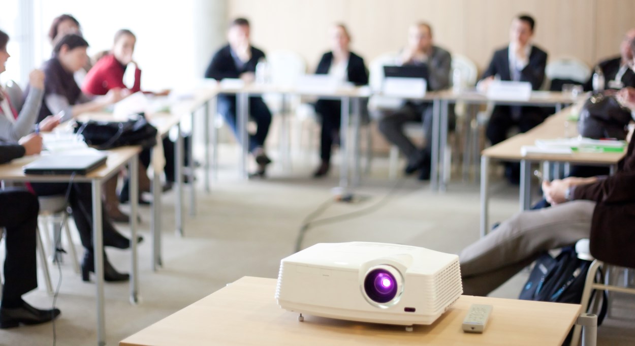 A group of people watching a presentation