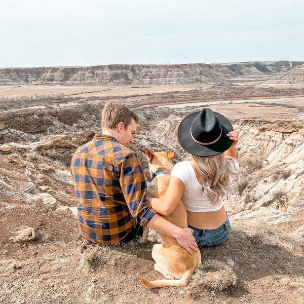 male and female with dog in badlands alberta
