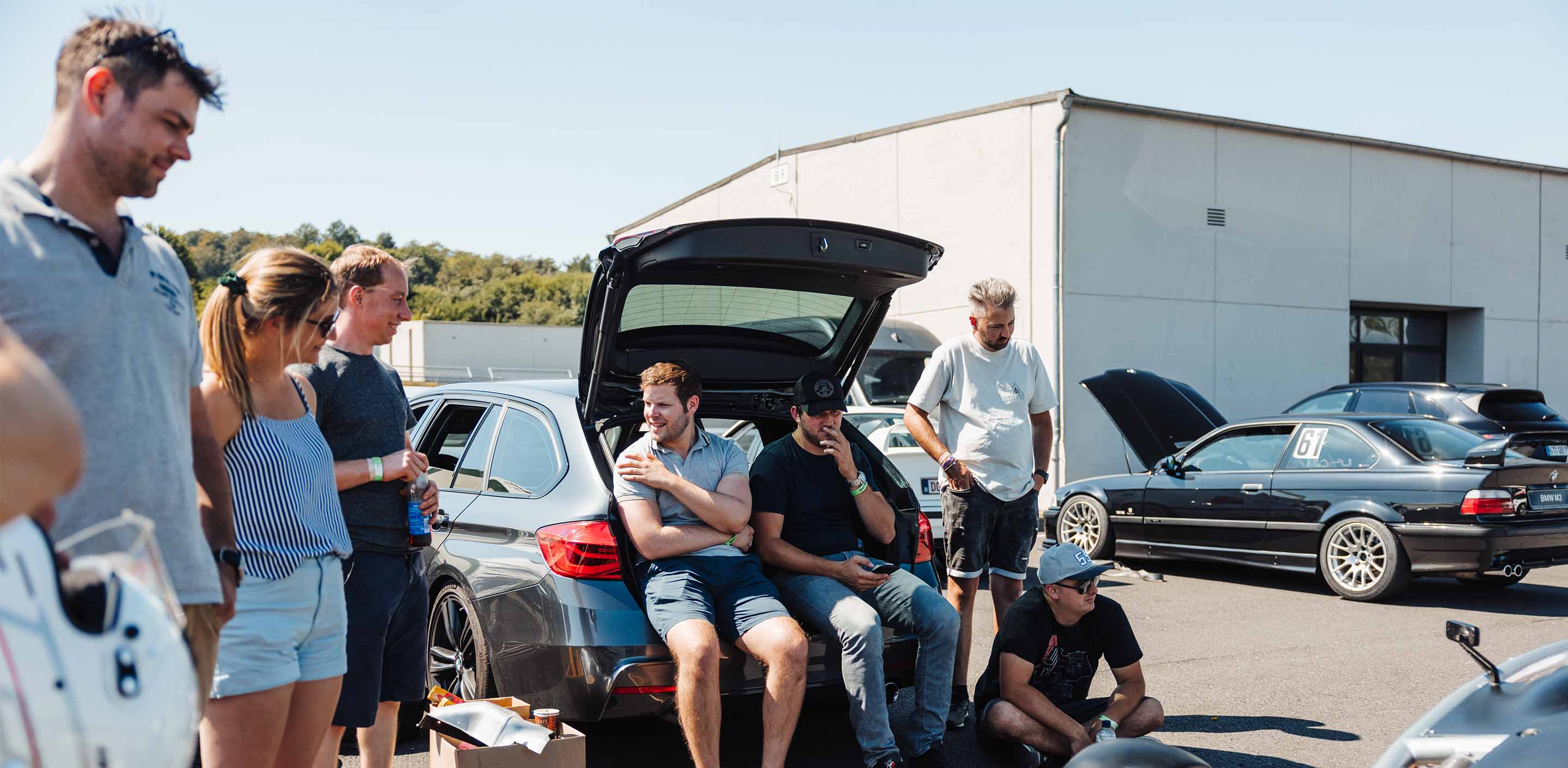 A group of Track Day participants is seen relaxing in the Paddock during a GP Days Open Pitlane Track Day at Bilster Berg