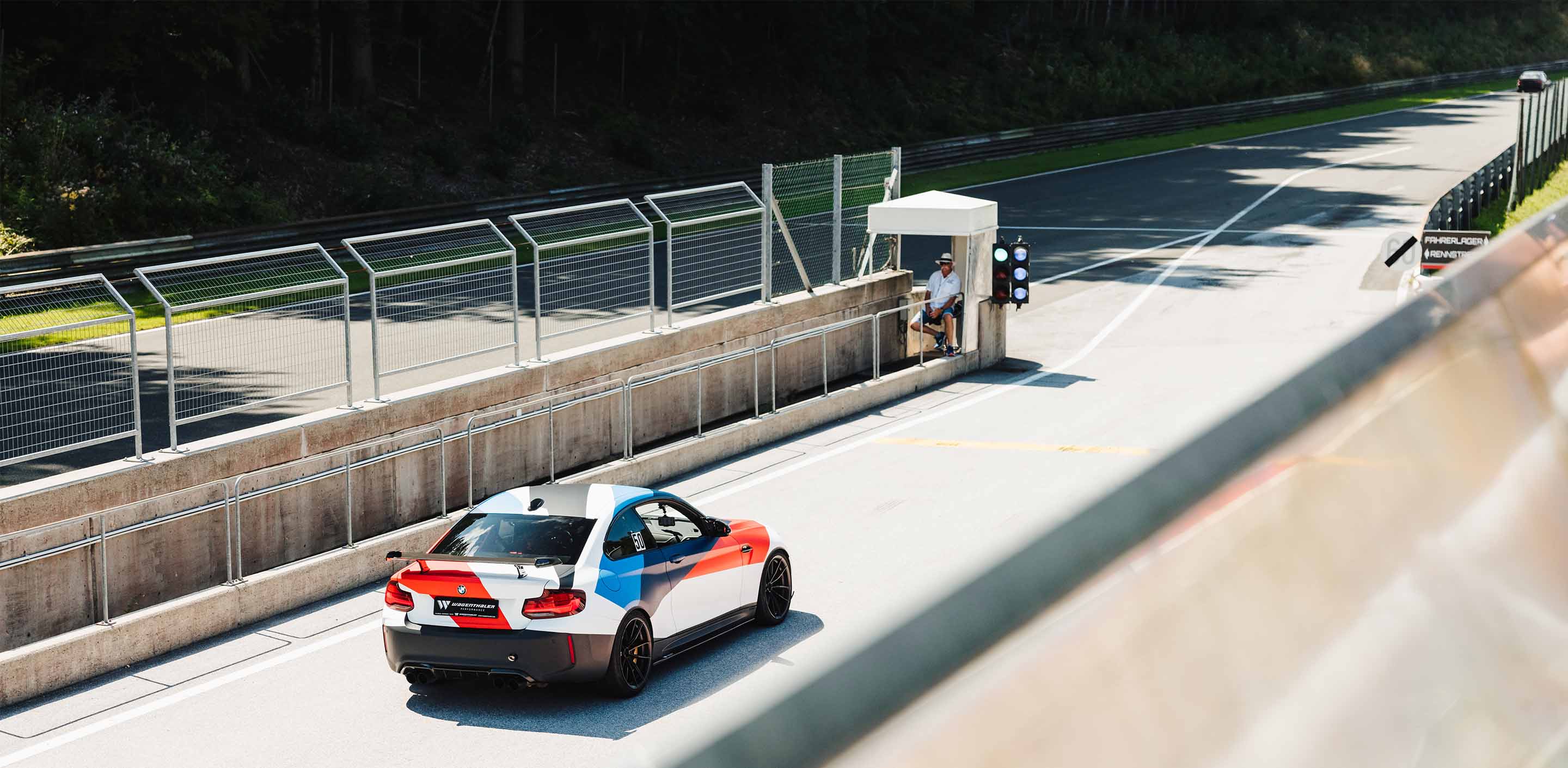 A BMW M2 leaving the pitlane during a GP Days Open Pitlane Track Day at Salzburgring