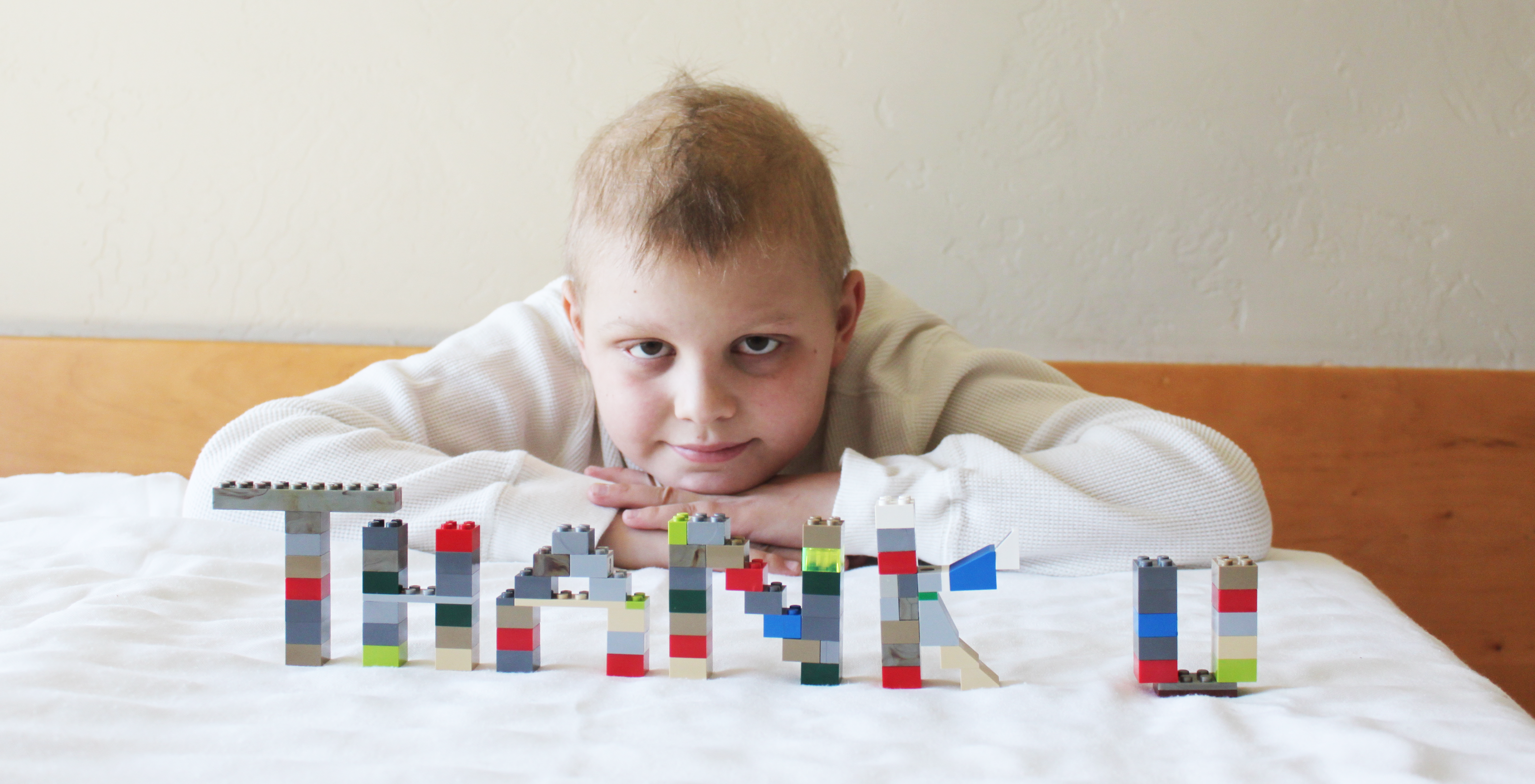 Peyton Armstrong during cancer treatment with, Thank You, written out in front of him in Legos