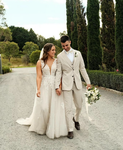 Bride and Groom holding hands walking and groom holding the bouquet