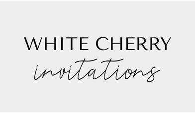 White cherry invitations black logo on grey background