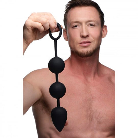 Homme tenant des perles anales en silicones noir-Le Royaume Du Plug