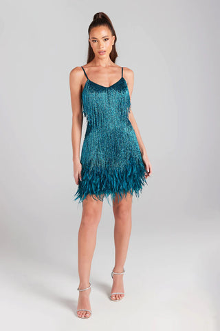 Woman wearing teal mini dress with crystal waterfall beading