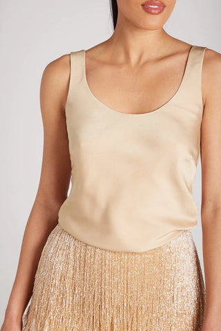 Woman wearing champagne coloured satin cami top