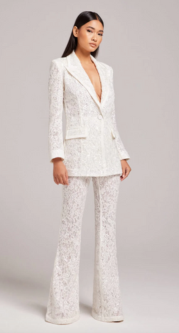 woman stood wearing Camilla white blazer with matching Camilla white pants