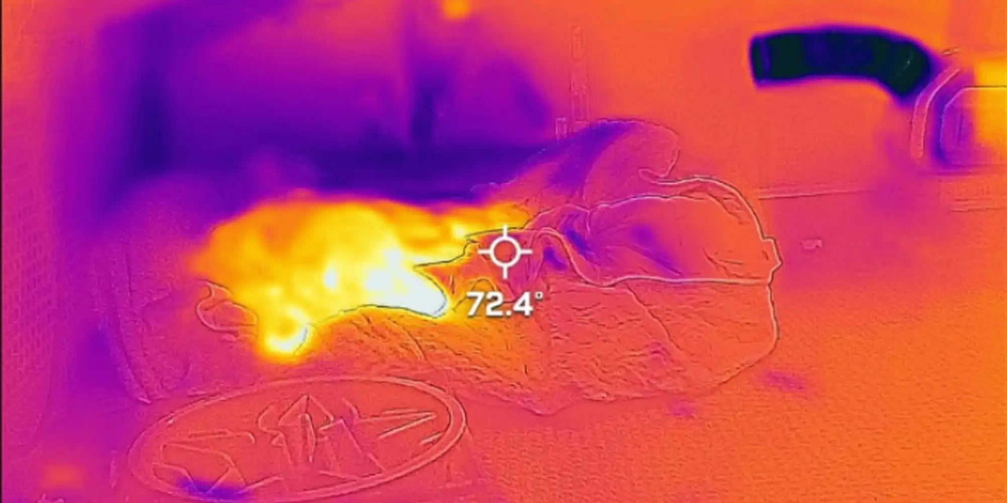 Thermal image shows a dog lying comfortably with a visible cool air stream directed at it from the Mark 2 portable AC, with the temperature reading 72.4°F, highlighting the effectiveness of spot cooling.