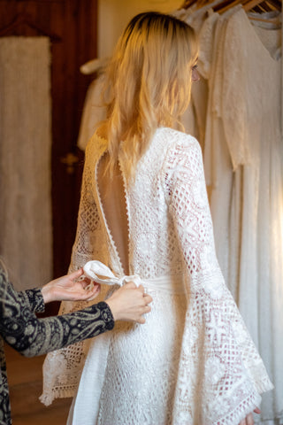 bohemian bride wearing lace dress and bell sleeves