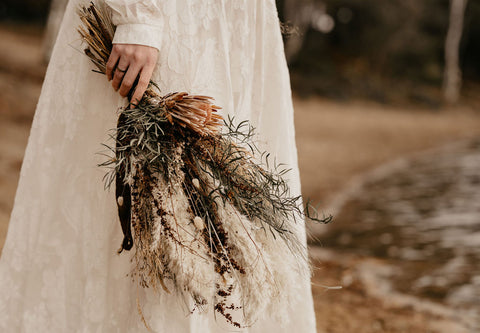 boho bridal bouquet and lace wedding dress