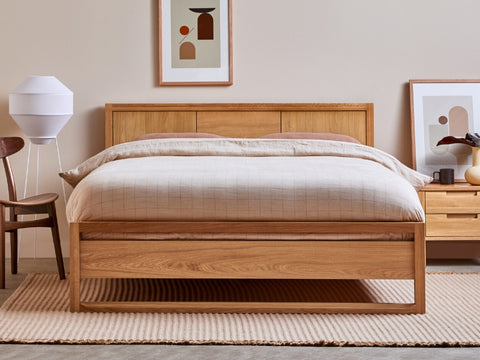 solid oak bed with white mattress