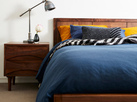 dark solid walnut bed and bedside table