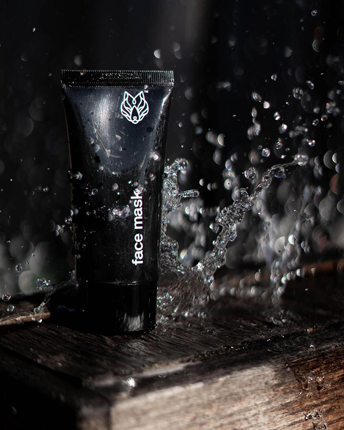 an action shot of a bottle of black wolf face mask