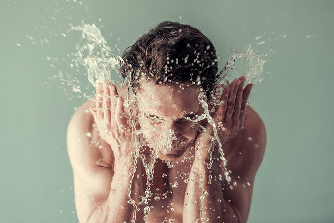 man washing his face