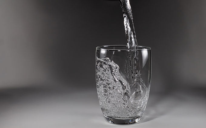 pouring water into glass