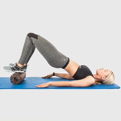 Girl Performing a Hip Bridge Using a Proworks Foam Roller